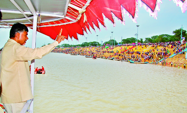 Chief Minister N. Chandrababu Naidu flashes V symbol to pilgrims, at pushkar, from a boat on Godavari river ghats in Rajahmundry on Friday. (Photo: DC) Chief Minister N. Chandrababu Naidu flashes V symbol to pilgrims, at pushkar, from a boat on Godavari river ghats in Rajahmundry on Friday. (Photo: DC)
